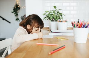 Cute preschooler girl learning home. Homeschooling, distance learning for kids.